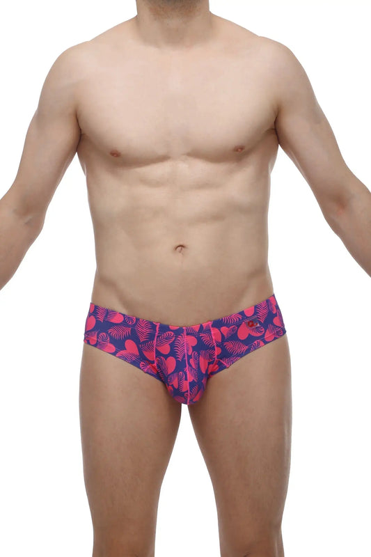 Vibrant pink and navy blue petitq mini boxer tropical hearts swim trunks with tropical leaf pattern for beachwear