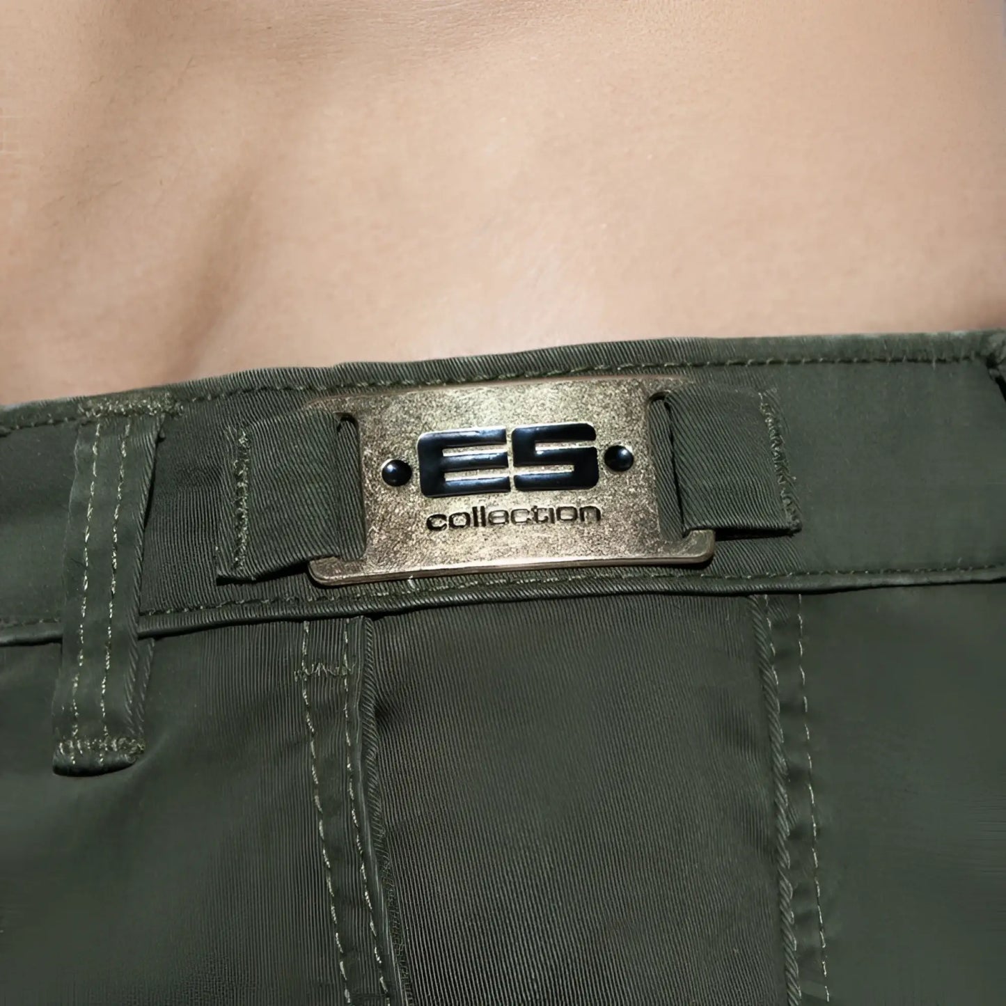 Olive green denim plain cargo short featuring a metallic silver es collection brand plaque with black lettering and rivets