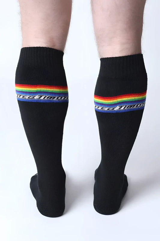 Black pride knee high socks with vibrant rainbow stripe and white military text below the stripe