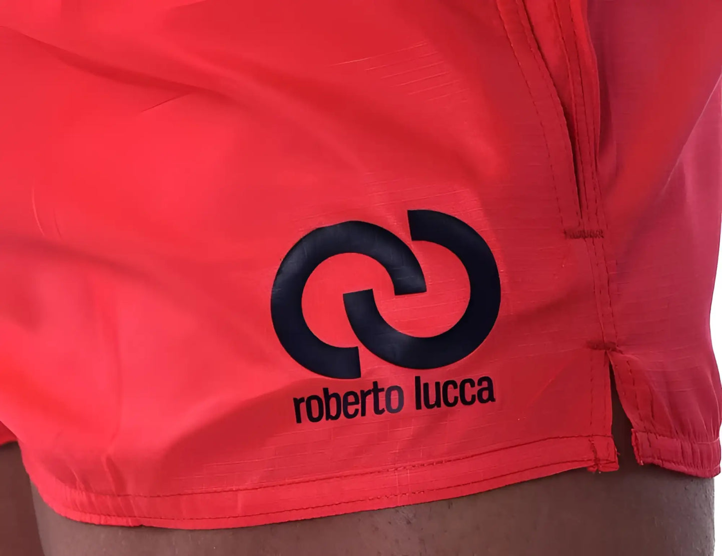 Bright red roberto lucca solid shorts with bold black logo and interlocking circle design swimwear size l