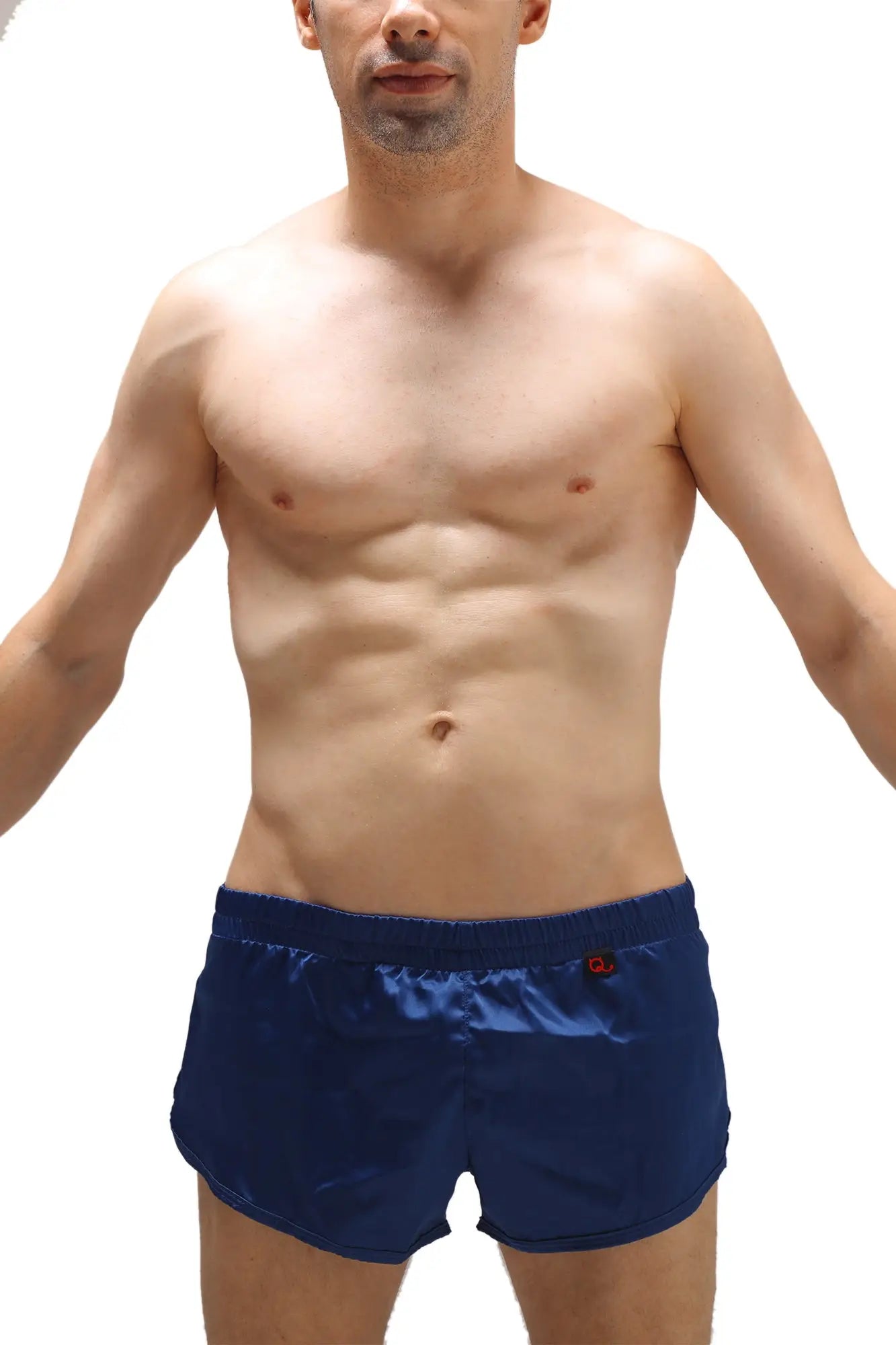 Navy blue satin swim trunks with a jockstrap and a small red logo on the waistband