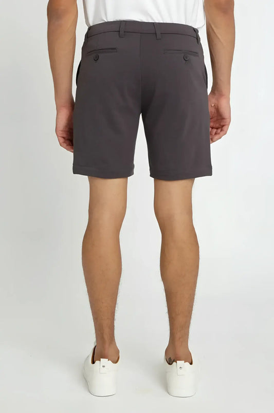Dark gray solid stretch knit chino shorts with tailored fit and buttoned back pockets shown from the back side
