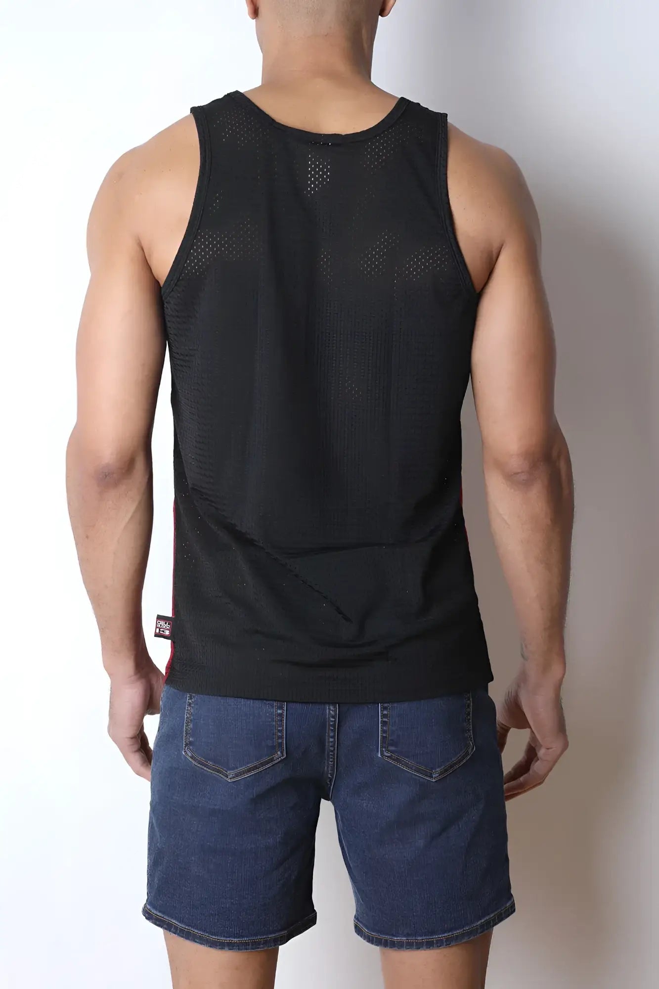 Black starter mesh tank top with subtle perforated texture and a small brand tag at the bottom hem