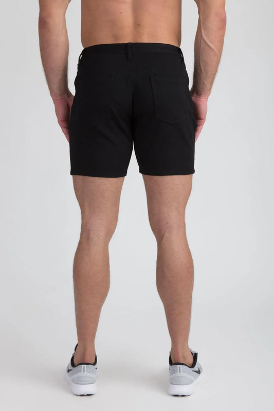 Black stretch knit short with tailored fit and two rear pockets shown from the back side