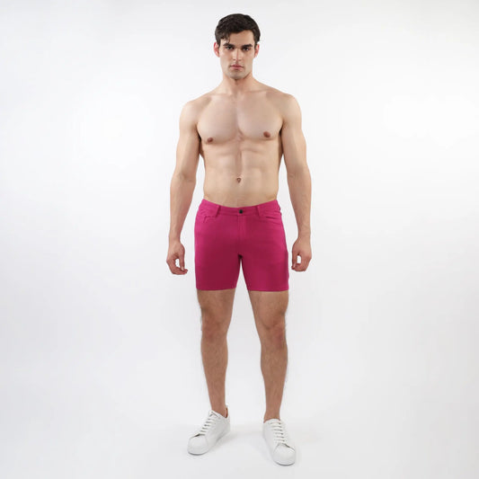 A pair of vibrant fuchsia stretch knit shorts with form-fitting modern design and subtle stitching details