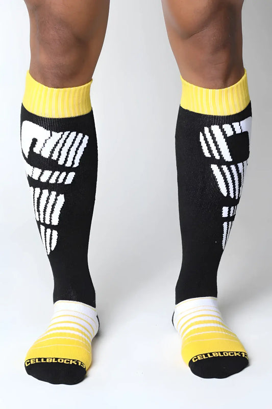 Velocity 2.0 knee high socks in black with bold white graphics and bright yellow ribbed cuffs toe caps and heel accents