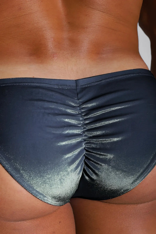 Shiny dark blue metallic velvety scrunch-butt bikini briefs with ruched back design shown from the back side