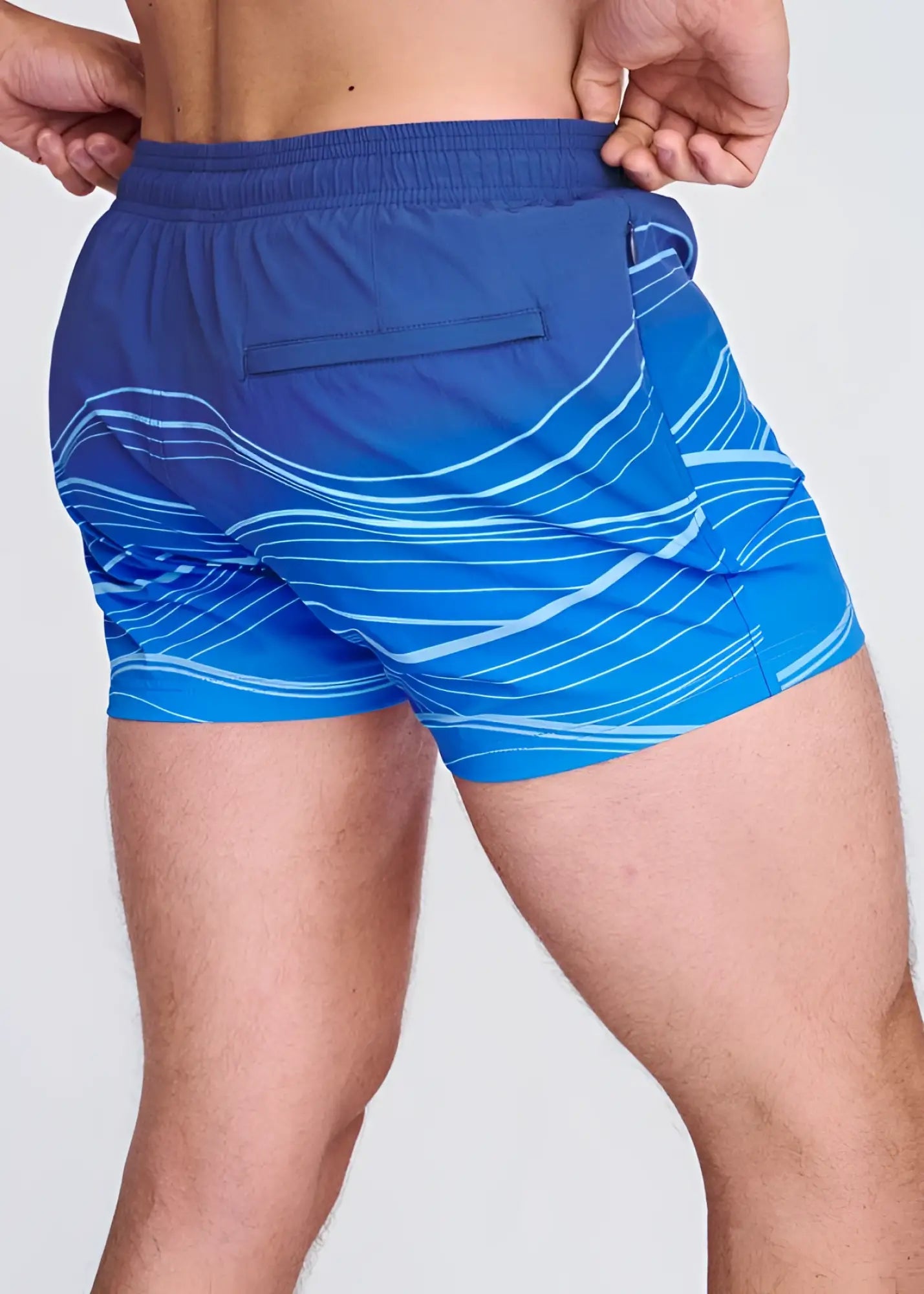 Blue waves print swim shorts with white wavy line pattern and mesh lining for comfortable beachwear