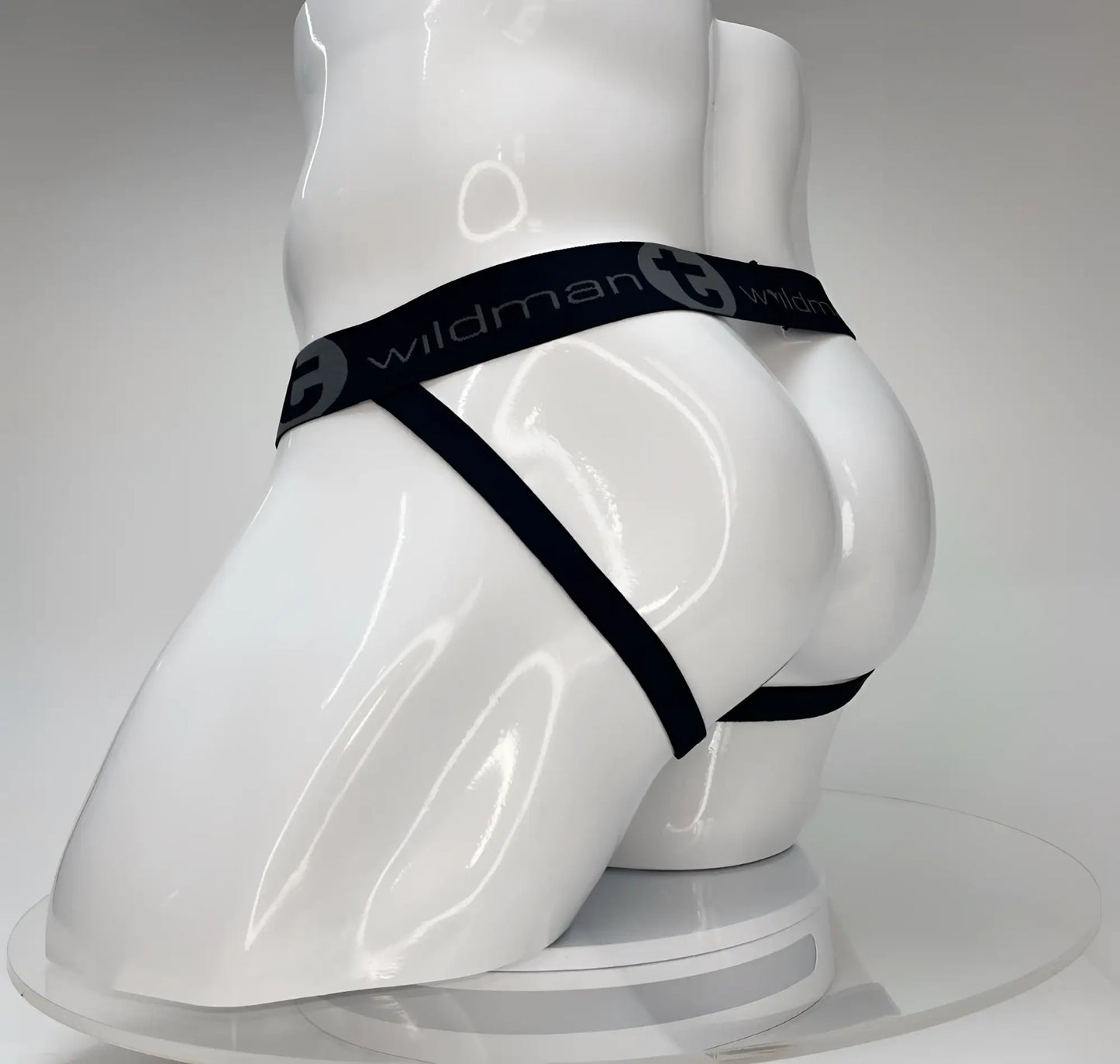 Black elastic waistband with wildman branding on white mannequin showing wildmant big boy pouch jockstrap white