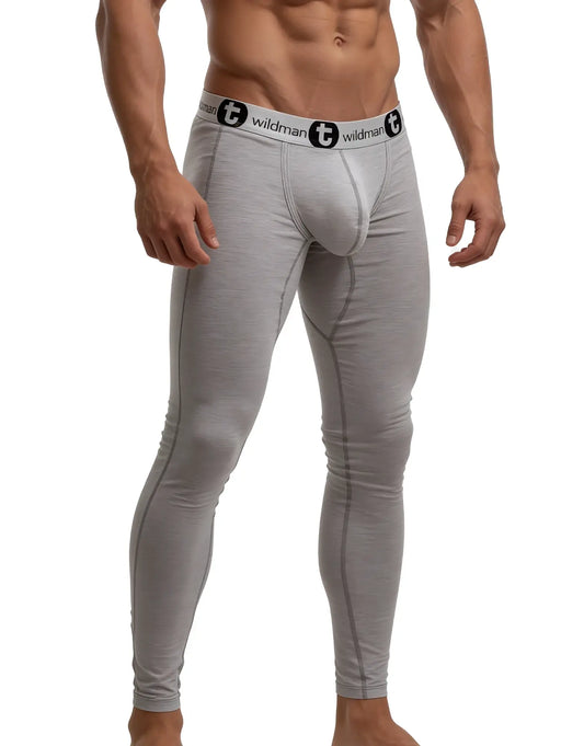 Grey WildmanT long johns featuring a contour pouch, fitted legs, and a logo waistband on a muscular model.