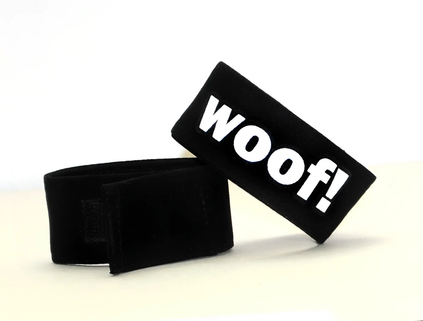Black velour pet collar strap with bold white woof lettering for wildmant fetish max cock-ring-woof product