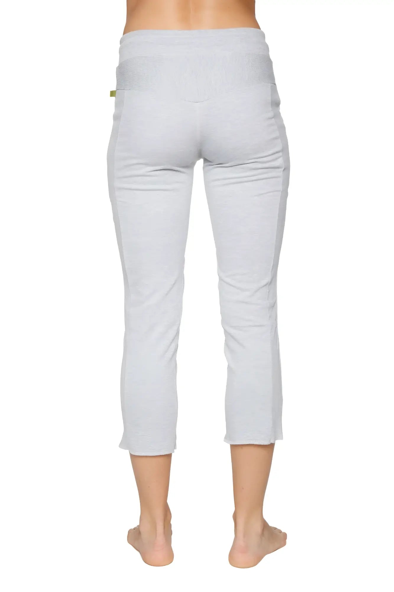 Back view of women’s heather grey 4/5 length zipper pocket capri yoga pants with soft texture and ribbed waistband
