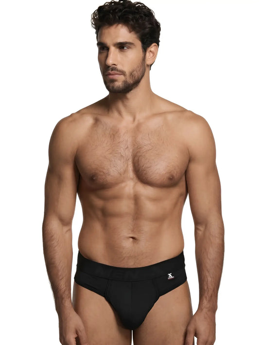 Xtremen black bikini briefs on a male model, featuring a matte fabric finish and logo-branded waistband.
