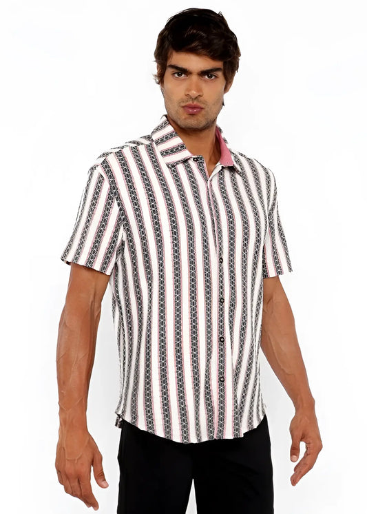 A man wearing a zigzag stripe open stretch knit shirt with vertical white gray and black geometric patterns