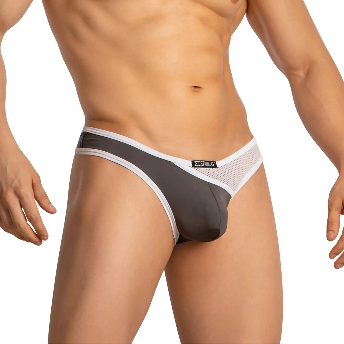 A man stands wearing gray and white mesh low rise underwear.