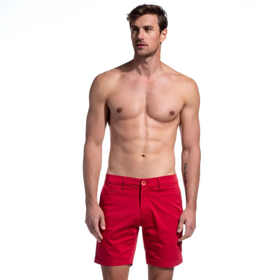Shirtless man wears red cotton shorts, standing against a plain white background.