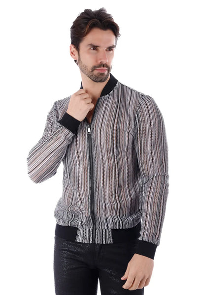 Man in striped knit zip-up jacket posing against a white studio background.
