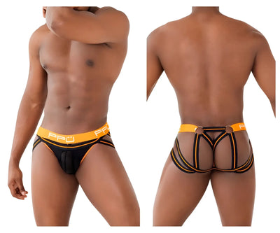 Man wears black and orange strappy briefs against a white background.
