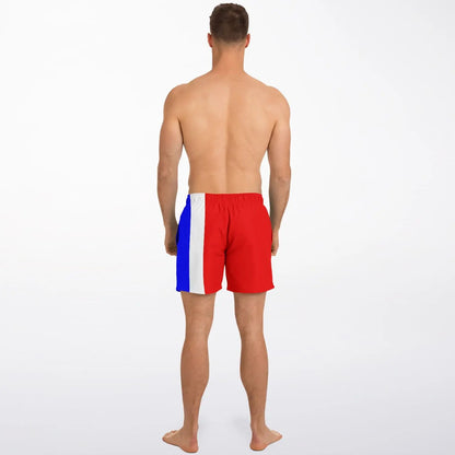 Men's swim shorts by Maris Equi in red blue and white with a color-block design shown on a model from the back.