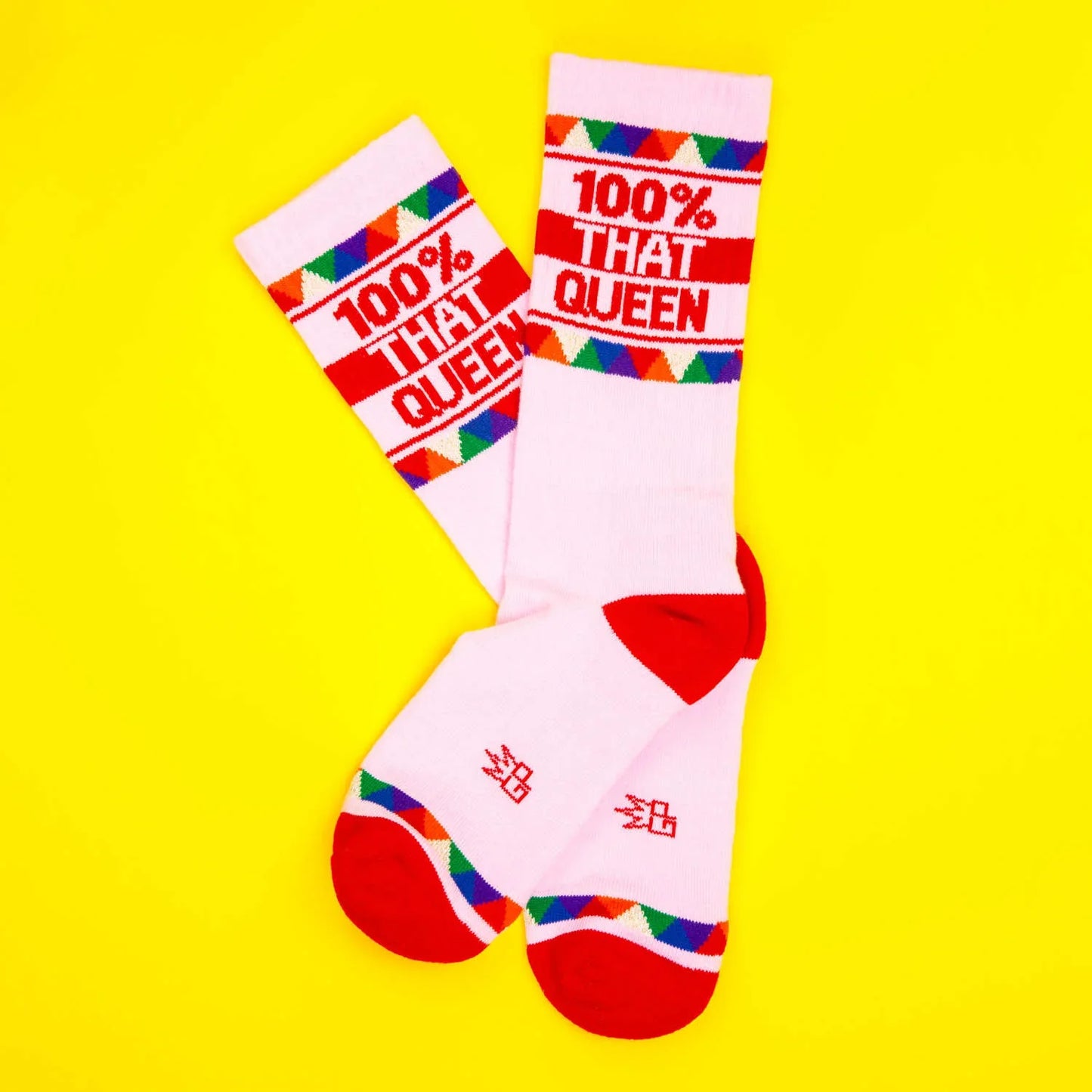 White crew socks with red accents and colorful triangles featuring bold red 100 percent that queen text on white background