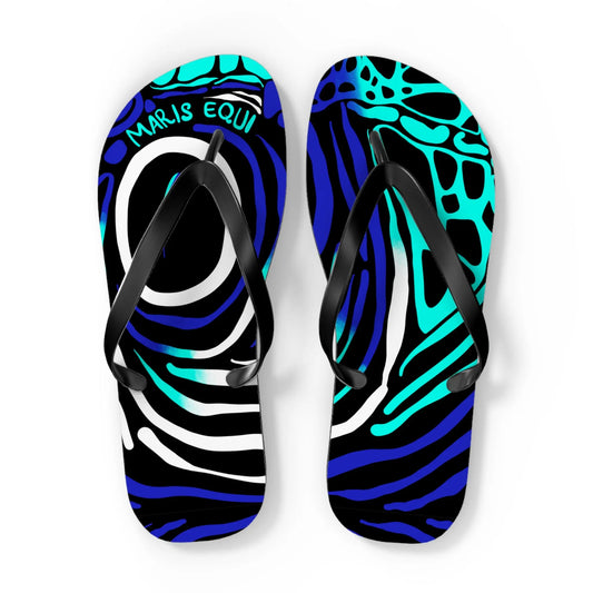 Colorful flip-flops with a blue and black abstract pattern featuring black straps by Maris Equi.