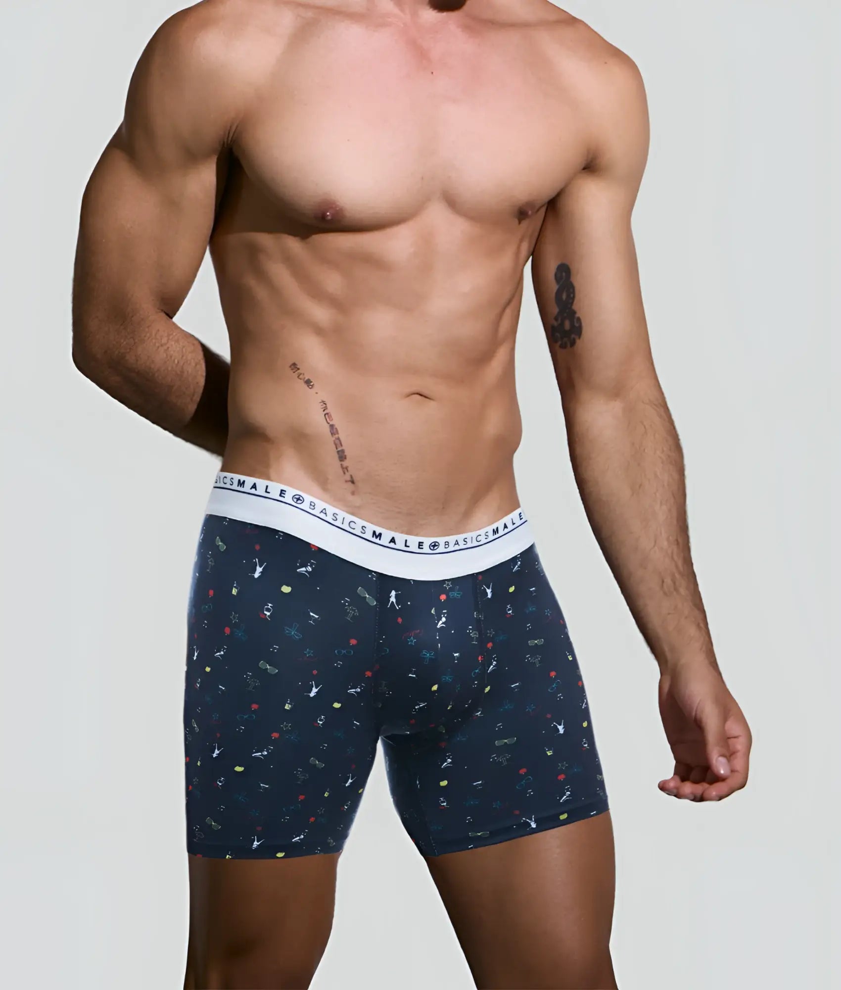 Navy blue malebasics boxer briefs with white elastic waistband and colorful abstract patterns from malebasics bundle