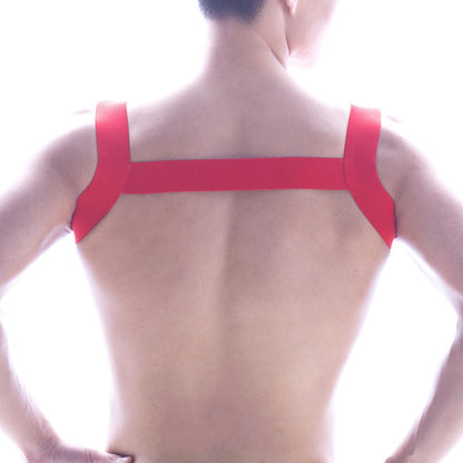 Back view of metromalewear logo harness red adhesive tape strapped in an x-shaped pattern on a person’s back