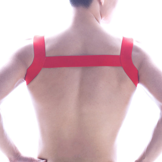Back view of metromalewear logo harness red adhesive tape strapped in an x-shaped pattern on a person’s back