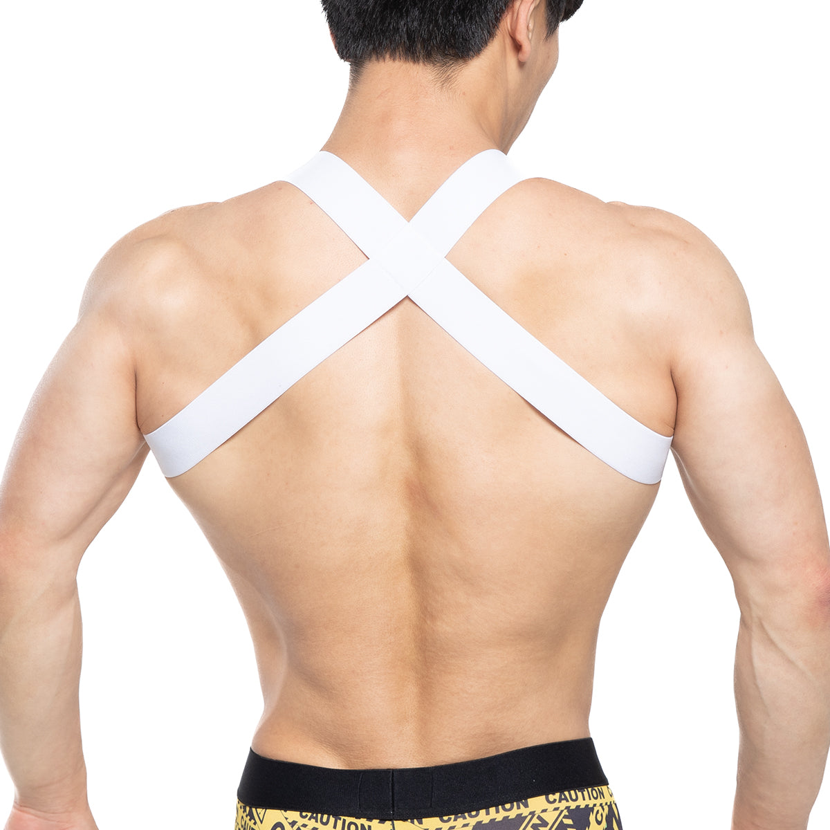 White cross-back athletic support strap worn over the shoulders showing the back side of metromalewear danger harness 1400-63