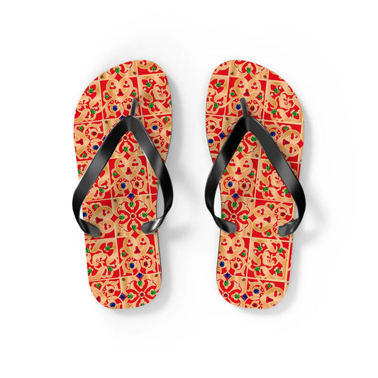 Colorful patterned flip-flops with black straps featuring a vibrant design by Maris Equi on a beige background.