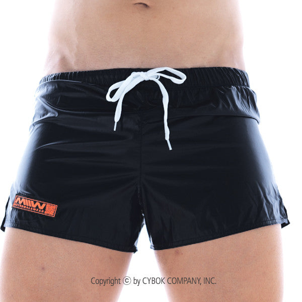 Black MetroMaleWear Iron Sports swim trunks with white drawstring and orange logo patch on left leg for activewear