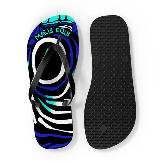 Colorful flip-flops with a blue and black abstract design featuring a black strap and textured black sole by Maris Equi