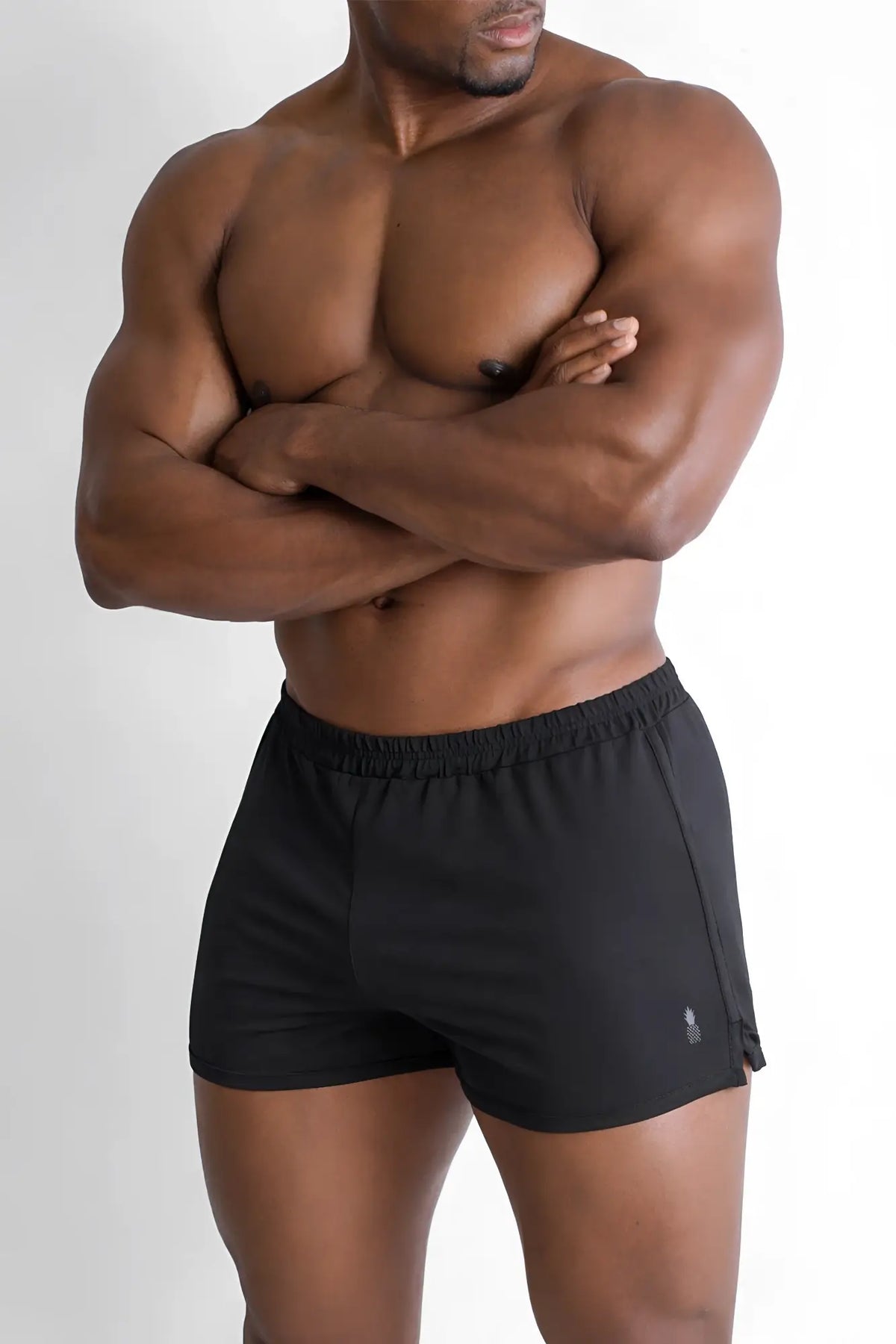 Black athletic 2 inch side split booty shorts in midnight black with subtle logo on the lower right leg