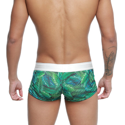 Green tropical leaf-patterned swim trunks with white elastic waistband by MetroMaleWear jungle trunk 2026-08