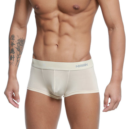 Cream-colored form-fitting men’s boxer briefs with a subtle gray logo on the waistband by metro male wear