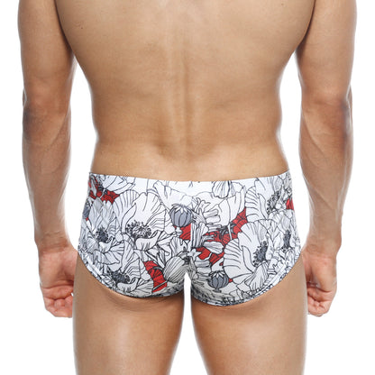 White swim trunks metro male wear oscar boxer escobar 2125-09 with bold floral pattern black outlines and red accents