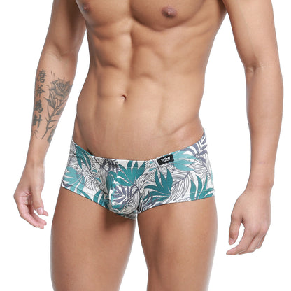 White briefs with vibrant teal and gray tropical leaf pattern and black metro male wear logo on waistband
