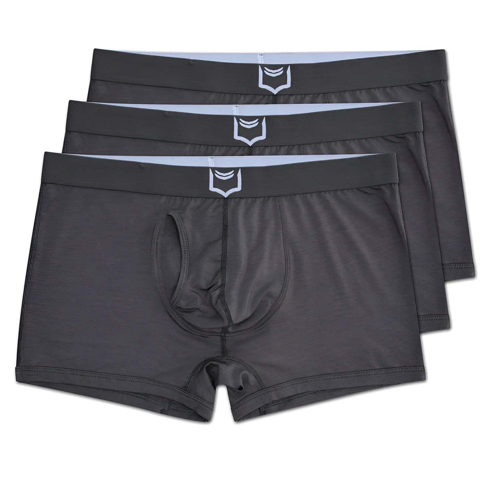 Dark gray men’s sheath 2.1 dual pouch trunks with a white shield logo on the waistband in a 3 pack bundle