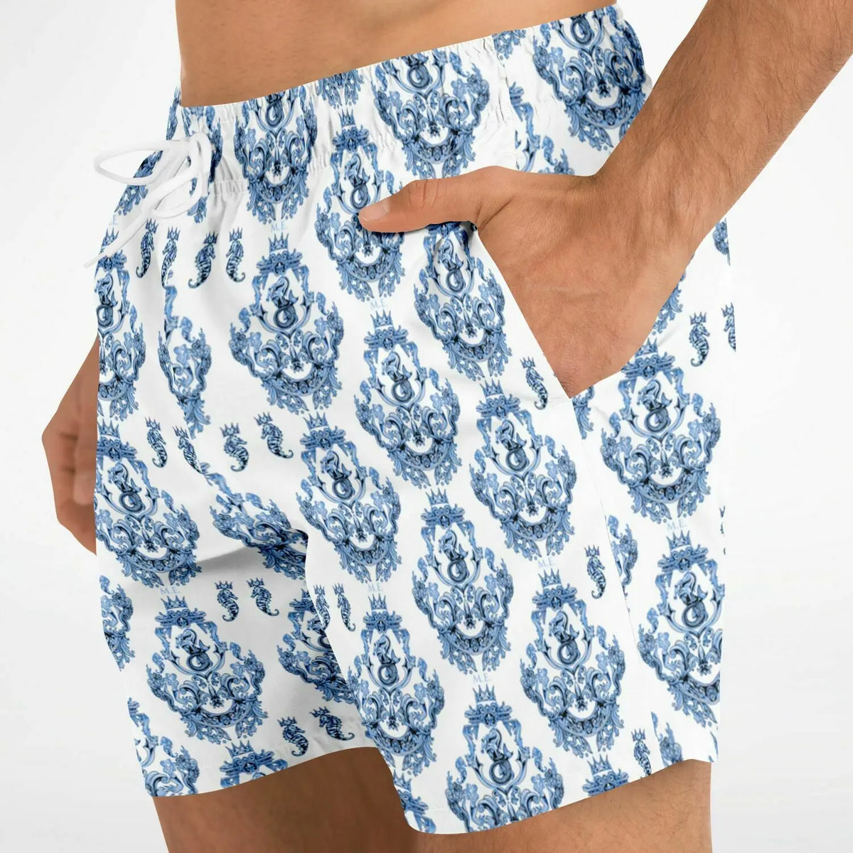 Men's swim shorts in white with blue baroque pattern featuring side pockets and an elastic waistband by Maris Equi.