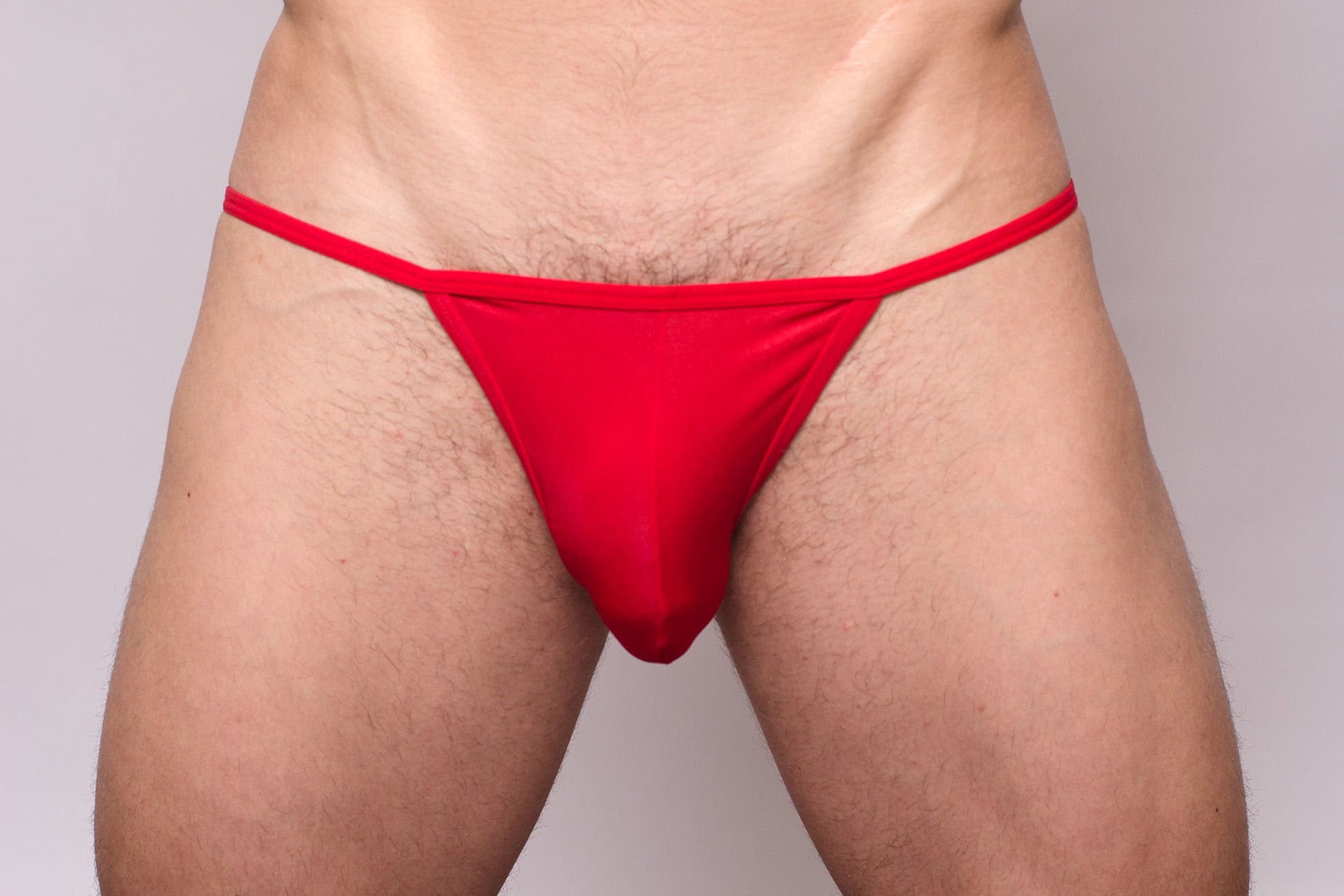 Red thong made of smooth stretchy fabric with a simple design shown from the back in 3-pack pride metro string bikini