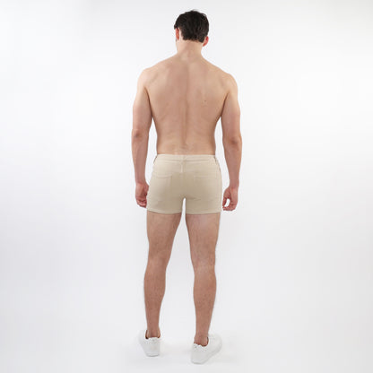 Beige 3 inch stretch knit short athletic briefs with sleek minimalist design and subtle stitching details