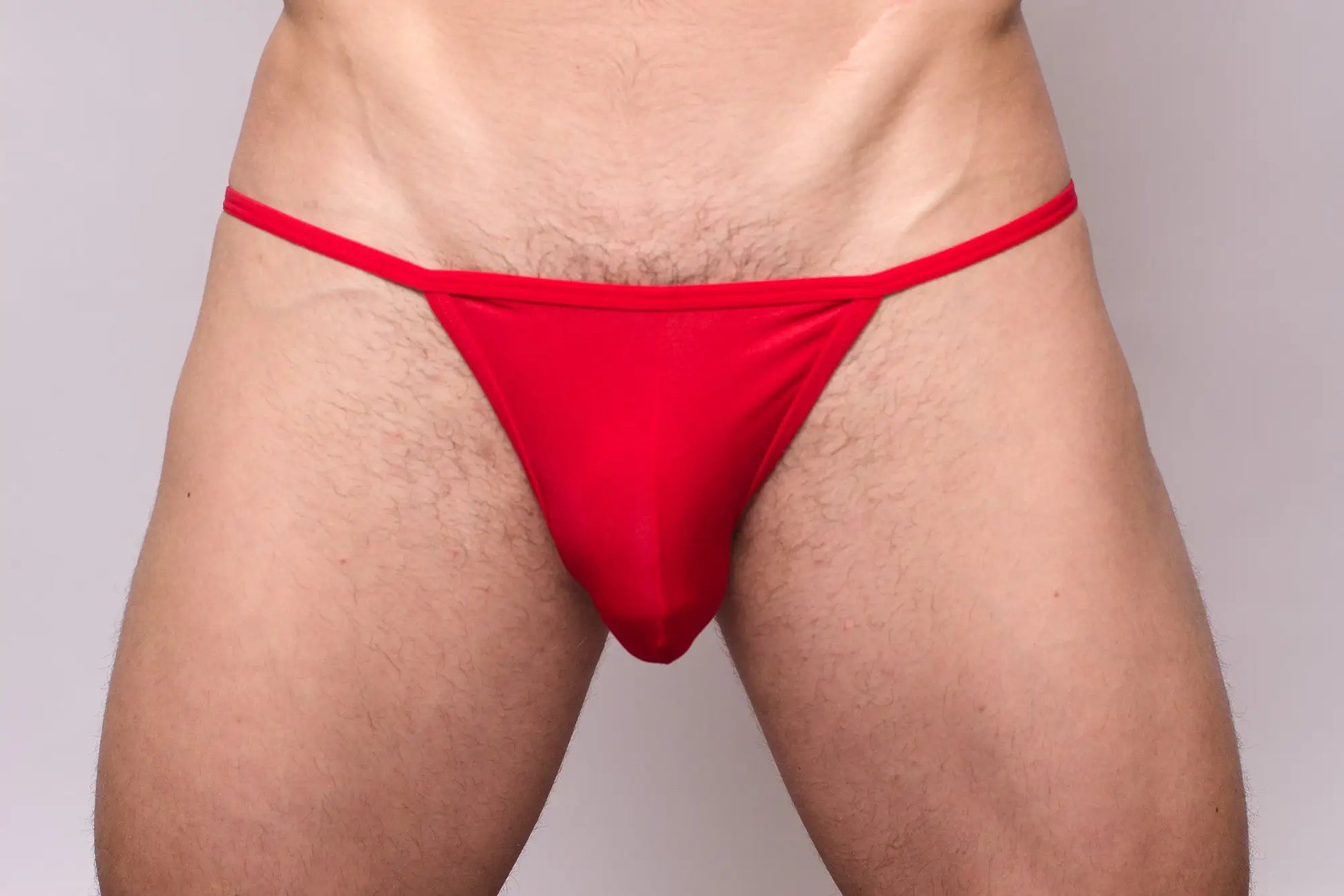 Red thong made of smooth stretchy fabric with a simple design shown from the back in 3-pack pride metro string bikini