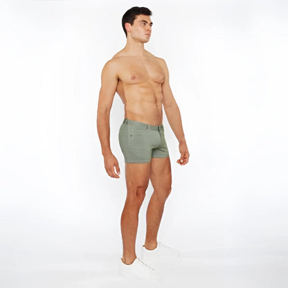 A pair of olive green slim-fit boxer shorts with stretch knit two-tone fabric and a modern textured design