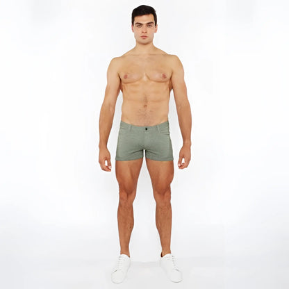 A pair of olive green 3 inch stretch knit two tone briefs with textured fabric pattern and button closure