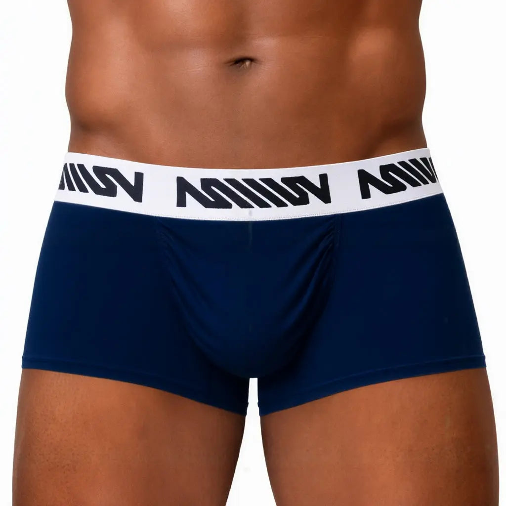 Dark blue men's trunk with a snug fit featuring a white branded waistband shown on a model.
