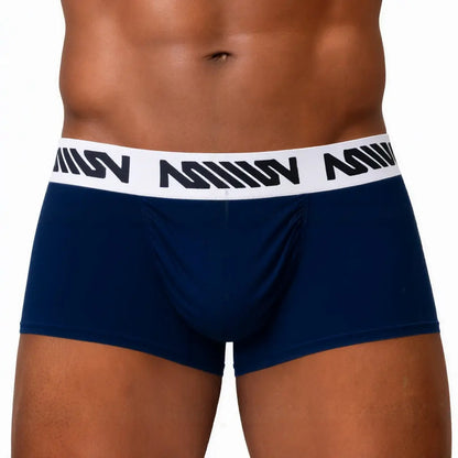 Dark blue men's trunk with a snug fit featuring a white branded waistband shown on a model.