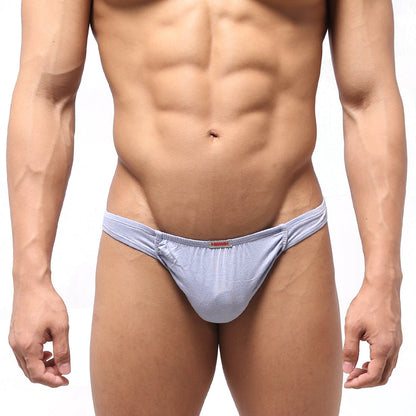 Light blue stretchy MetroMaleWear Bosillo Thong briefs with subtle texture and a small red brand tag at the waistband