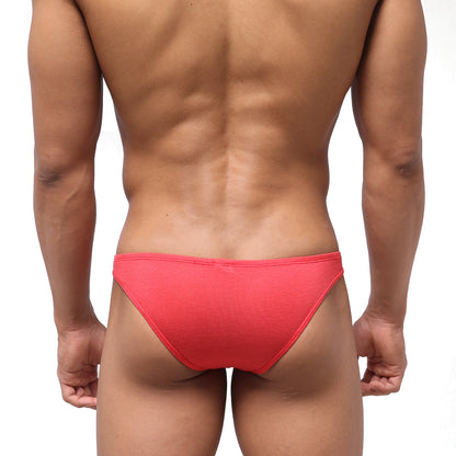 Bright coral-red metroMalewear bosillo half back bikini briefs with textured seamless fabric shown from the back side