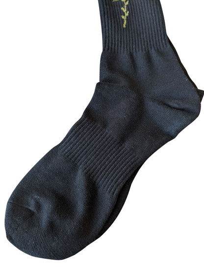 4 rth black sport sock made of ribbed knit fabric with an olive green vine embroidery near the cuff