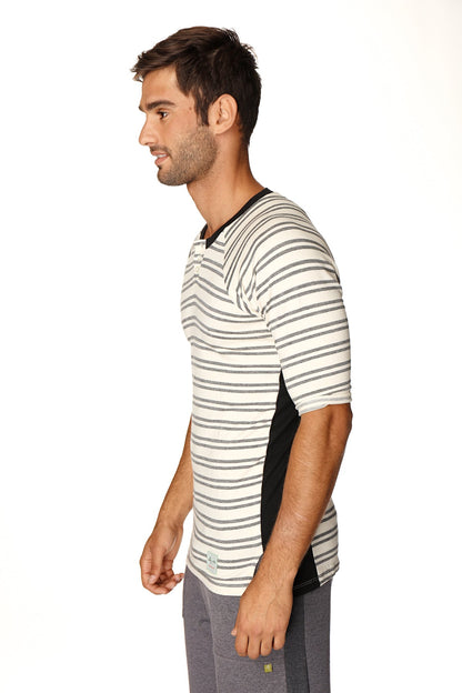 A man wearing a 4-rth mens vintage-stripe henley tee in dark grey double stripe french terry with black side panels
